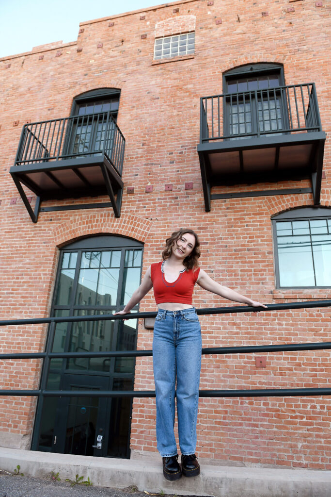 Senior portrait with brick building in Historic Downtown Yuma, Arizona